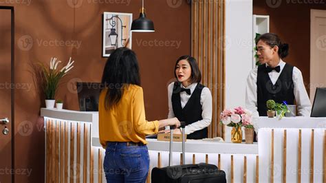 hotel front desk interaction guest staff check-in modern lobby experience