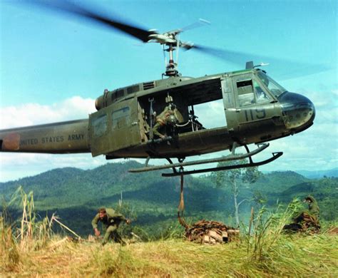 Huey helicopter flying above Vietnam jungle