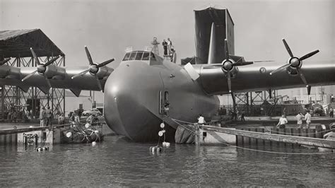 Hughes H-4 Hercules Spruce Goose floating on water showing enormous wooden wings