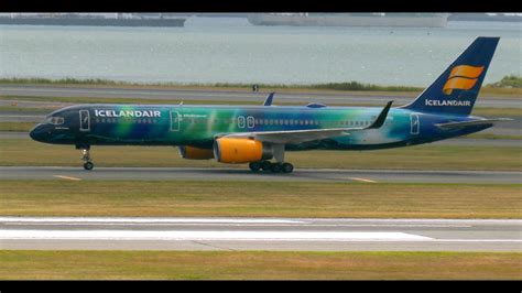 Icelandair jet taxiing at Keflavík International Airport with snowy mountains in background