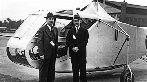 Igor Sikorsky with VS-300 framed in hangar background