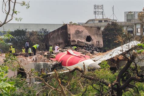 Indian aviation officials inspecting a grounded Boeing 787 Dreamliner post-AI171 crash