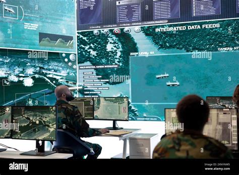 Indian defense personnel monitoring air drill operations from radar control center in Rajasthan
