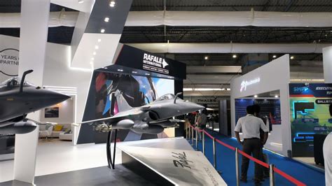 Indian defense scientists presenting jet engine models during Aero India exhibition