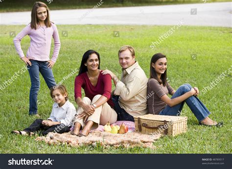 indian family enjoying picnic in canberra park with native flora