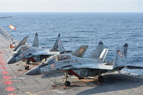 Indian Navy MiG-29K parked aboard INS Vikramaditya under monsoon sky