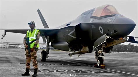 Indian security forces and technical teams inspecting the Royal Navy F-35B on Thiruvananthapuram tarmac