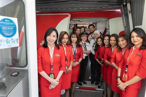 Indonesia AirAsia cabin crew welcoming Adelaide passengers onboard