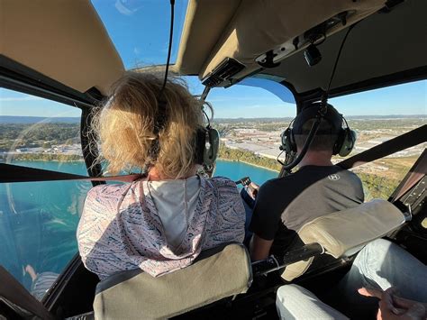 influencer filming aerial footage during private helicopter ride over South Carolina forest