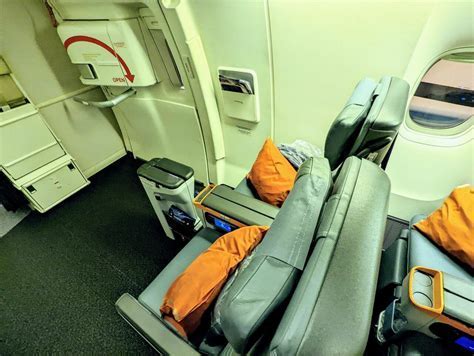 inside cabin of budget airline showing minimal legroom and no frills