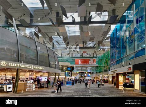 Inside the Cyril E. King Airport terminal with duty-free shops and arriving passengers