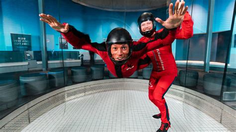 instructor guiding child inside iFLY tunnel in Union City with clear safety gear