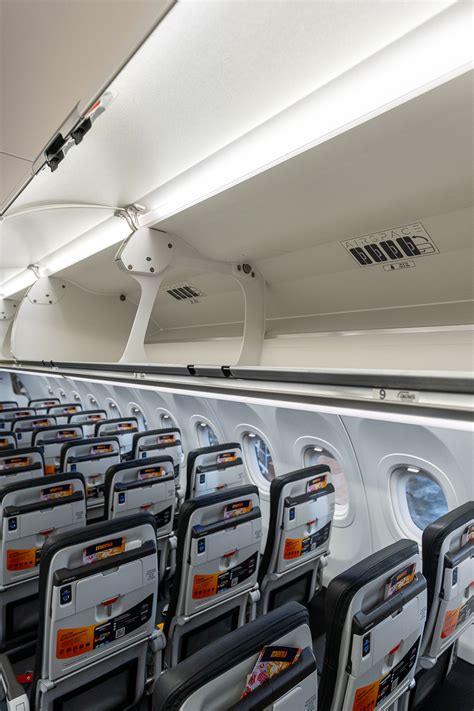 interior cabin of jetstar a320neo showing tight seat pitch and no screens