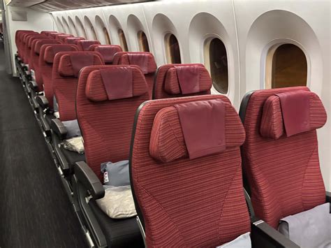 interior of a low-cost airline cabin with closely packed non-reclining seats