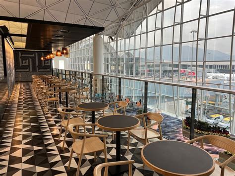 Interior of a modern and spacious airport lounge, possibly JAL Sakura Lounge or Qantas Hong Kong Lounge