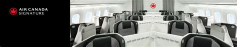 Interior of Air Canada Signature Class cabin with lie-flat seats and ambient lighting