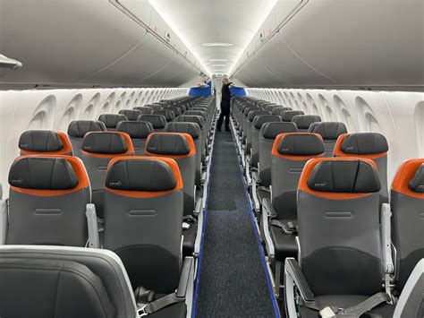 interior of JetBlue Airbus A220-300 showcasing wider seats and advanced IFE system