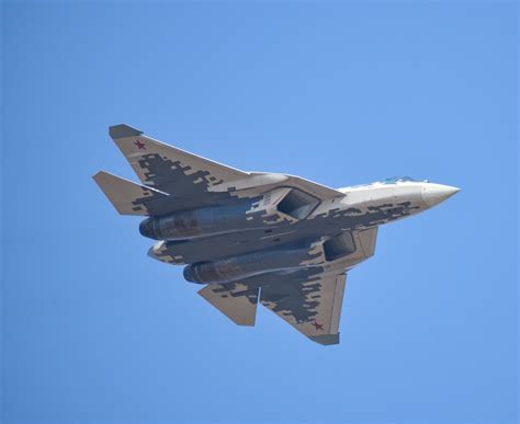 international air show featuring a Su-57 performing aerial maneuvers