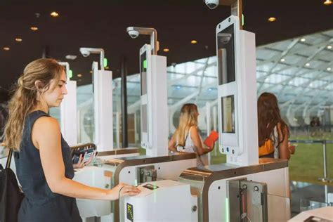 international travelers using biometric gates at dubai airport summer 2025