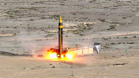 Iranian ballistic missile launch test with desert launch platform and rising smoke plume
