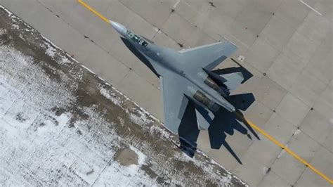 J-16 fighter jet flying over military airbase