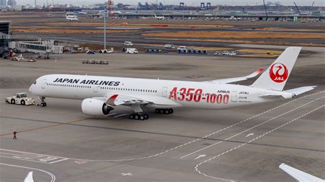Japan Airlines Airbus A350-1000 on tarmac at Tokyo Haneda Airport with Mount Fuji in the background