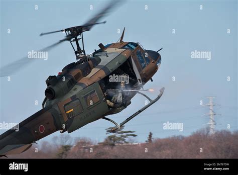Japan Ground Self-Defense Force AH-64DJP helicopter in flight over mountainous terrain