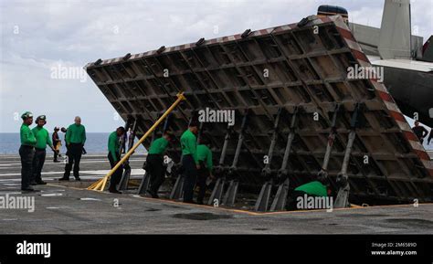 jet blast deflector in use aboard aircraft carrier USS Abraham Lincoln