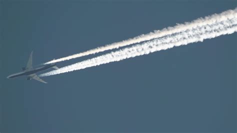 jet flying at high altitude with a faint contrail dissipating into clear sky, illustrating controlled routing