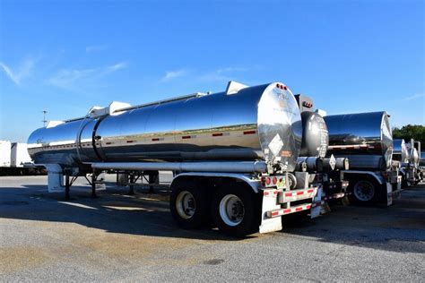 jet fuel tanker trucks loading at refinery during high demand period