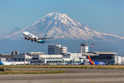 JetBlue aircraft taxiing at Seattle-Tacoma International Airport with Mount Rainier in background