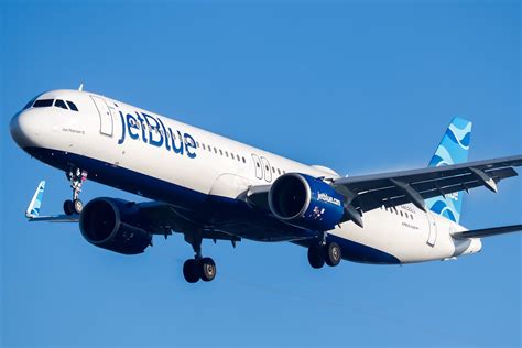 jetblue airways airbus a220 ready for takeoff with SAF banner