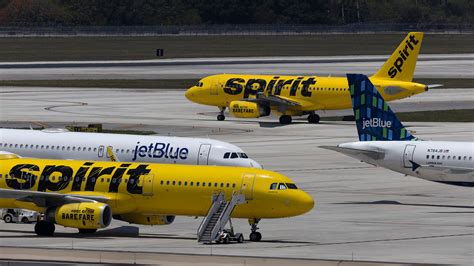 JetBlue and Spirit aircraft at adjacent gates during merger speculation period