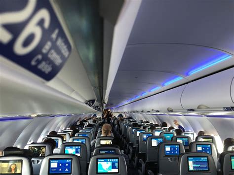 JetBlue cabin interior showing passengers boarding