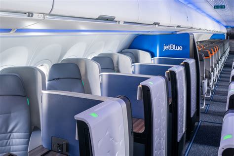 JetBlue daytime transatlantic flight cabin window sunlight business class