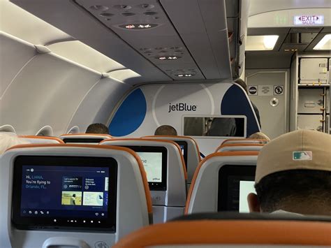 jetblue plane boarding passengers at tropical destination airport