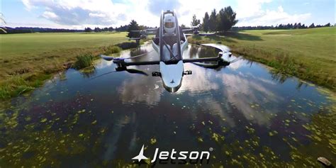 jetson one flying over open countryside with forest backdrop