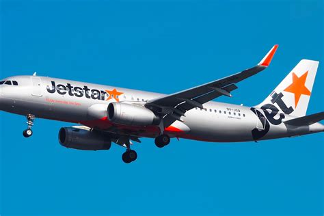 jetstar airbus a320 taxiing at gold coast airport near surfers paradise backdrop