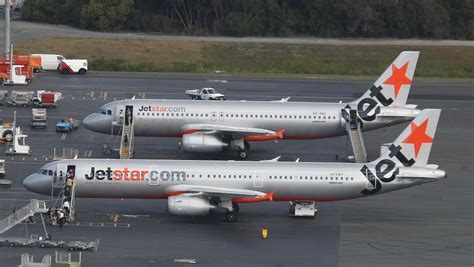 Jetstar and Tigerair aircraft side-by-side at an airport gate