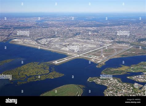 John F Kennedy International Airport terminals and runways with Manhattan skyline in distance