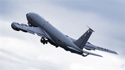 KC-135 Stratotanker performing aerial refueling with large aircraft