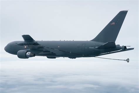 KC-46 Pegasus aerial refueling boom extending toward military aircraft