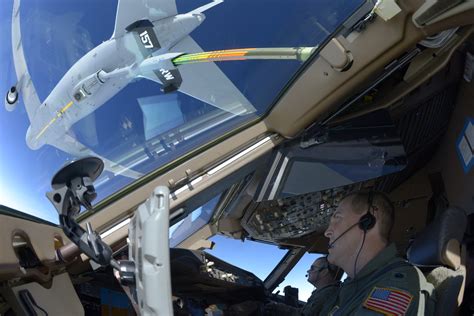 KC-46 Pegasus boom operator controlling aerial refueling with fighter aircraft