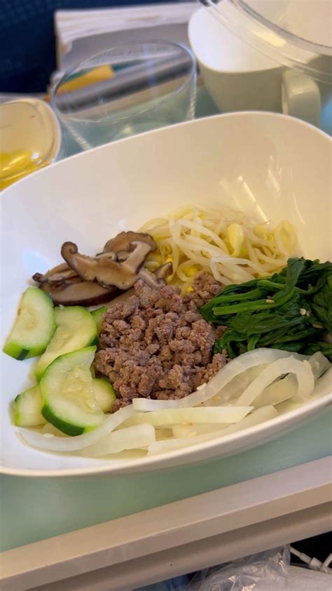 Korean Air Economy Class meal featuring Bibimbap with traditional accompaniments