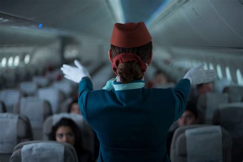 lead flight attendant conducting preflight safety briefing in narrowbody cabin
