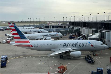 lineup of major U.S. airline aircraft at airport gates