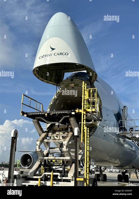 Lockheed C-5 Galaxy parked on military flight line with nose door open cargo loading