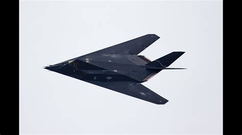 Lockheed F-117 Nighthawk flying at dusk with stealth profile visible