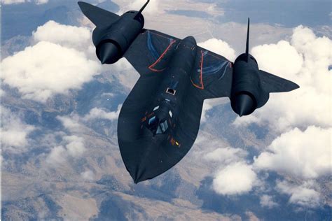 Lockheed SR-71 Blackbird flying at high altitude over desert terrain