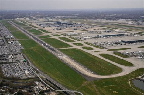 London Heathrow Airport runway with multiple widebody aircraft including British Airways and Delta Air Lines departures